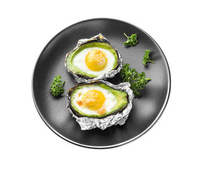 Baked avocado with eggs on white background