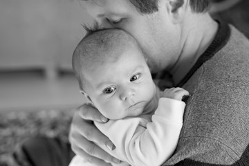 Happy proud young father with newborn baby daughter, family portrait togehter