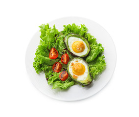 Baked avocado with eggs and vegetables on white background