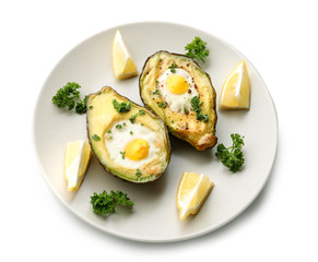 Baked avocado with eggs on white background
