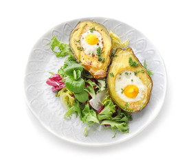 Baked avocado with eggs and vegetables on white background