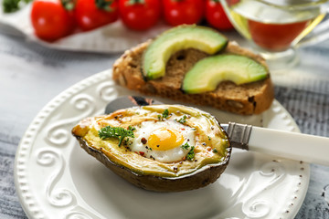 Baked avocado with egg on table