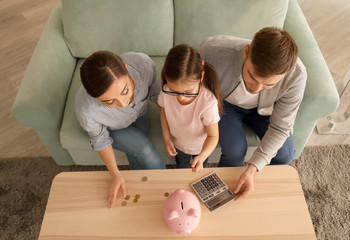 Family counting money indoors. Money savings concept