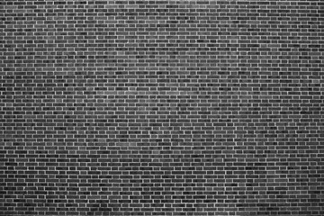 Old realistic brick wall made of black brick in different shads. Burnt smooth brickwork.