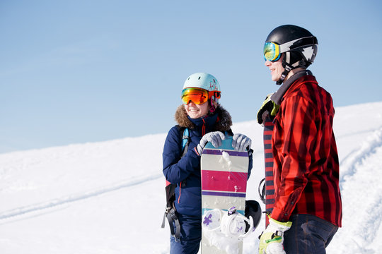 Image of sports woman and man with snowboard on vacation