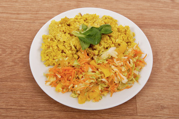 Baked Bulgar with cauliflower and vegetable salad on a table