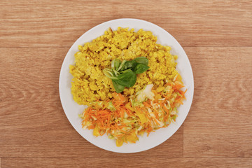 Baked Bulgar with cauliflower and vegetable salad on a table