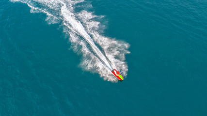People are playing jet ski at sea during the holidays. Aerial view and top view.