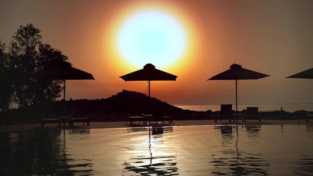 sunset by swimming pool 