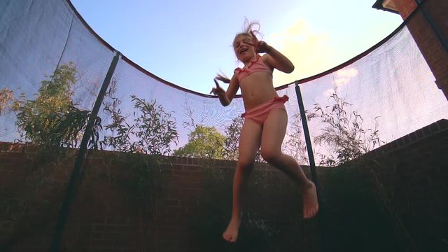 Girl jumping on trampoline slow motion