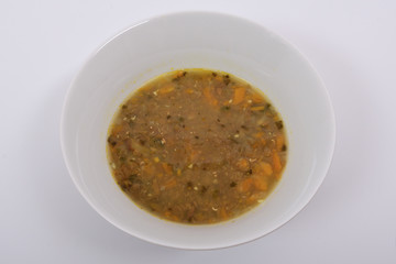 Lentil soup with carrot on a white