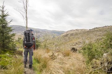 Backpacker Hiking through Hills