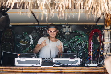 dj plays on the equipment in the summer disco