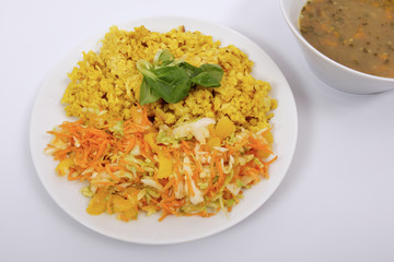 Baked Bulgar with cauliflower and vegetable salad on a white