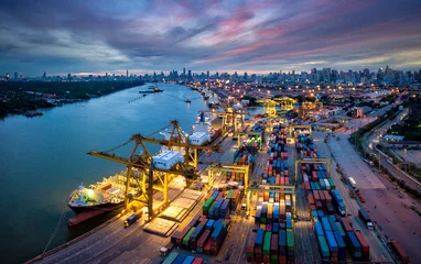 Foto op Plexiglas Aerial view of international port with Crane loading containers in import export business logistics  © Travel man