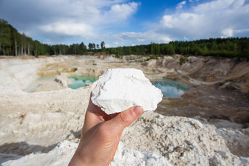 Open pit quarry ore white kaoline mining with blue sky and water