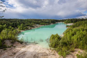 Flooded open pit quarry ore kaoline mining with blue water