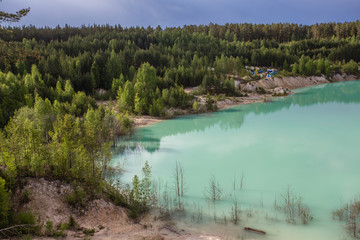 Fototapeta na wymiar Flooded open pit quarry ore kaoline mining with blue water