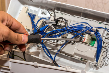 the man repairs the electronics of the washing machine