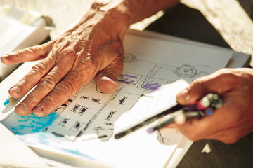 Close up man working of Architect sketching a construction project on his plane project at site construction work