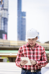 Fototapeta premium Asian business and engineer man with red scott shirt has planning and working for design buiding and city.
