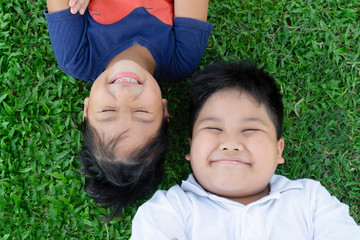 brother and sister lying