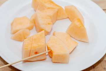 close up of sliced of melon on plate