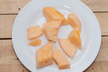close up of sliced of melon on plate