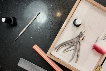 Set of manicure tools on manicurist workplace in beauty salon