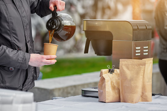 Coffee break service on outdoor event, man pouring coffee - Powered by Adobe