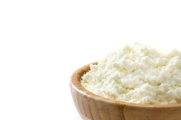 Fresh cottage cheese in a wooden bowl isolated on white background. Copyspace