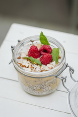 Healty diet breakfast. Jar with chia seeds and raspberry.