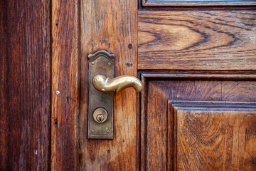 Fototapeta na wymiar close up view of rustic wooden door with steel handle