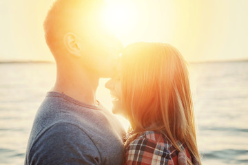 Fototapeta premium couple happy on the beach sunset romantic kiss close-up