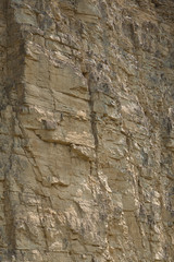 impressive huge steep wall in a surface quarry, stone texture, can be used as background
