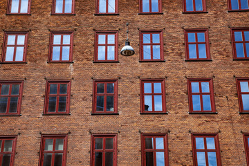 Full frame of city building brick wall with windows in Copenhagen, denmark