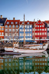 COPENHAGEN, DENMARK - MAY 6, 2018: boats and beautiful historical buildings reflected in calm water, copenhagen, denmark - obrazy, fototapety, plakaty