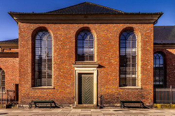 Fototapeta na wymiar beautiful brown building with large windows in empty street in copenhagen, denmark