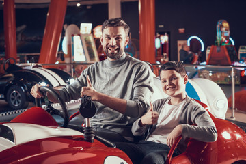 Fototapeta na wymiar Joyfull smiling father and son in amusement center