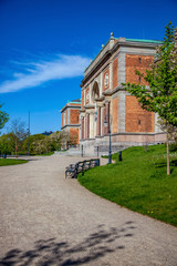 empty path and benches near beautiful old building in copenhagen, denmark
