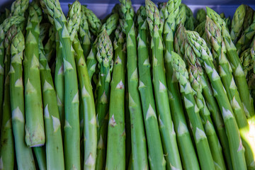 close up view of pile of asparagus on blurred background