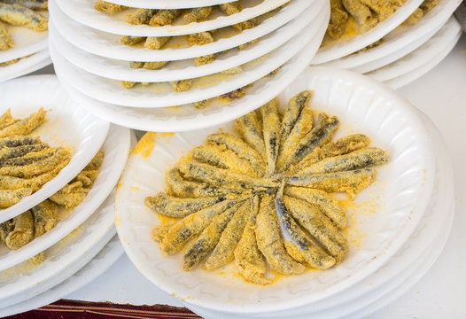 Set of plates with fried anchovies fish