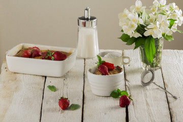 Cottage cheese casserole in white dish decorated with strawberries