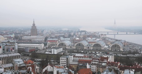 Riga, Latvia. Top View Cityscape In Misty Fog Rainy Day. Latvian Academy Of Sciences, Bus Station Riga International Coach Terminal And Riga Central Market