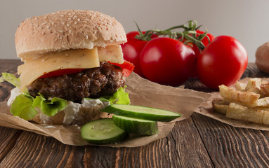 Delicious burgers with beef, tomato, cheese and lettuce