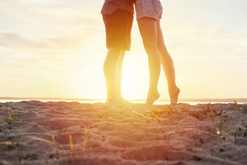 couple happy on the beach legs sand sunset