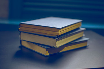 Vintage old books on wooden deck table