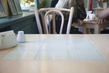 Table in a cafe In a blurry background, visitors