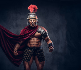 Brutal ancient Greece warrior with a muscular body in battle uniforms screams in battle agony