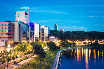 Vilnius city business area panorama with office buildings on the bank of the river during twilight blue hour in VIlnius, Lithuania